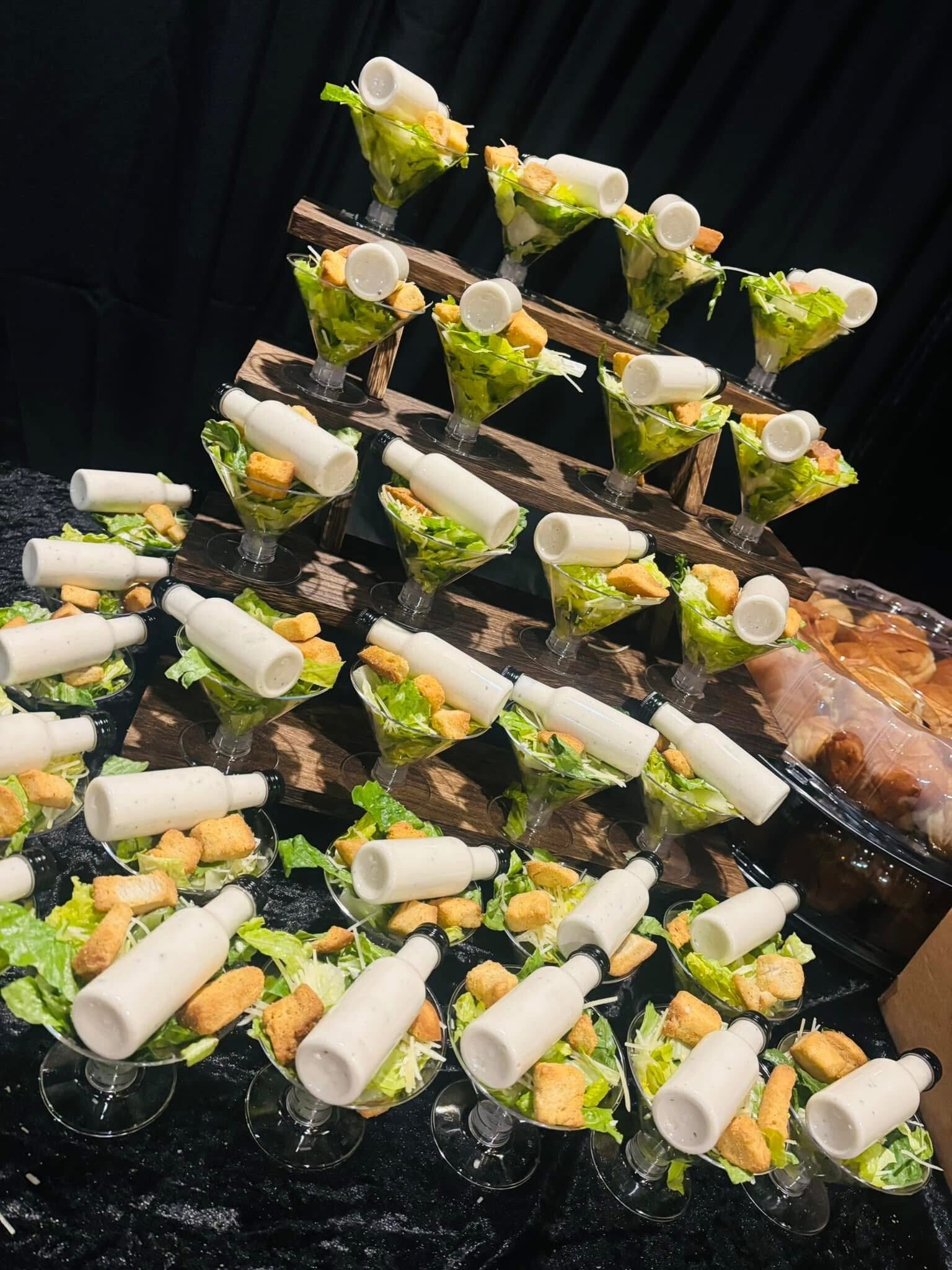 Individual salads displayed for a catered event